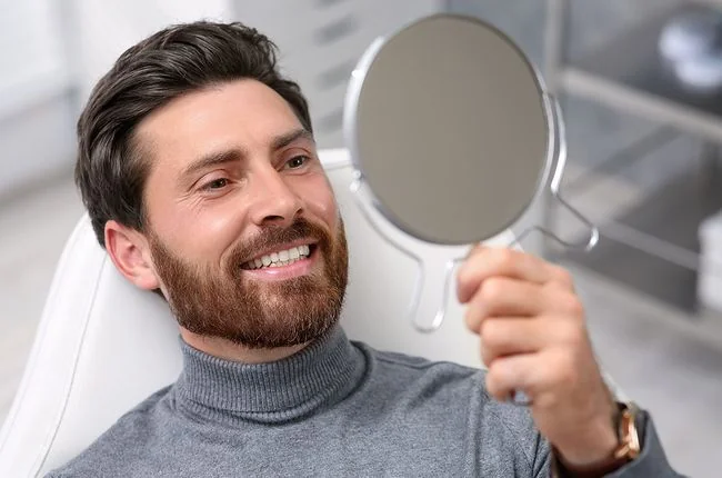 Dentistry The Dalles OR Dental Patient Checking Smile in Mirror