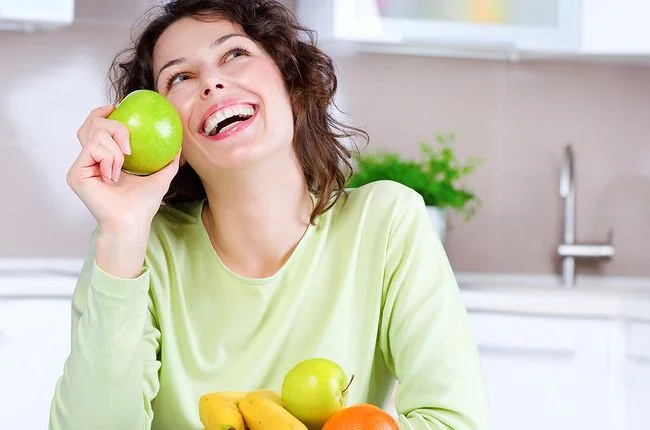 Dentistry The Dalles OR Woman smiling holding green